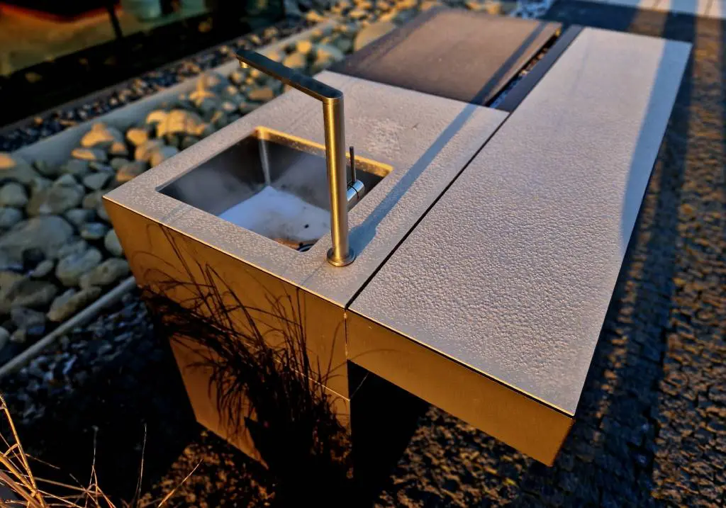 A gorgeous stainless steel outdoor sink installation within a backyard bartop A gorgeous stainless steel outdoor sink installation within a backyard bartop.