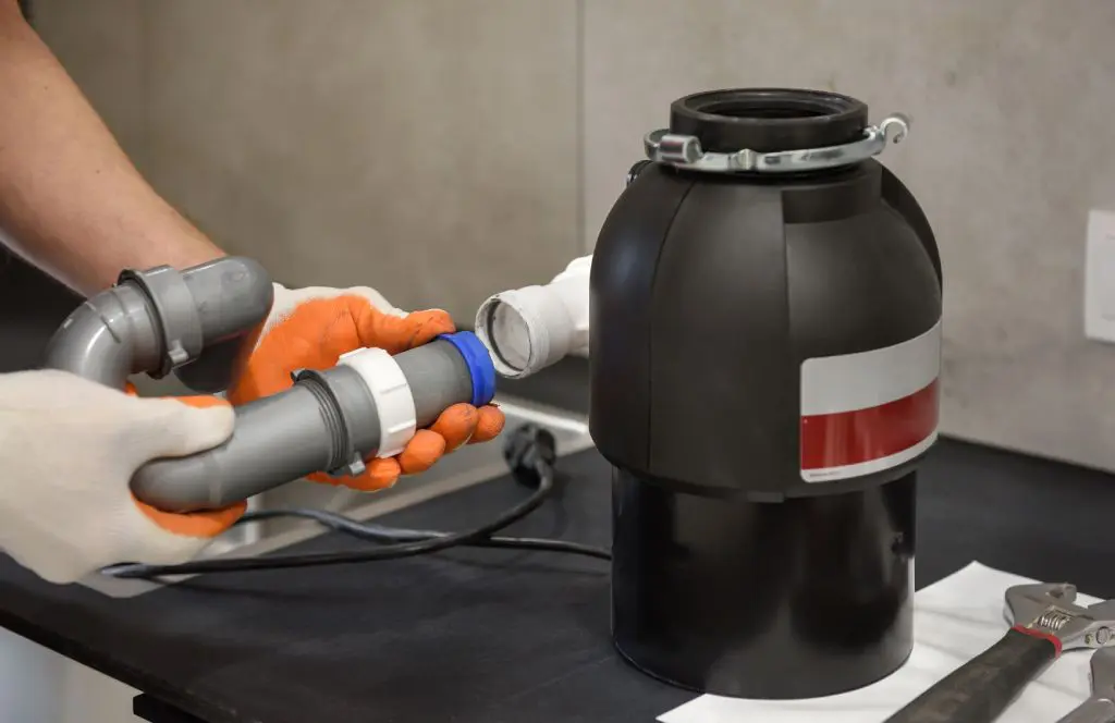 An XO DIYer putting together their new garbage disposal replacement.