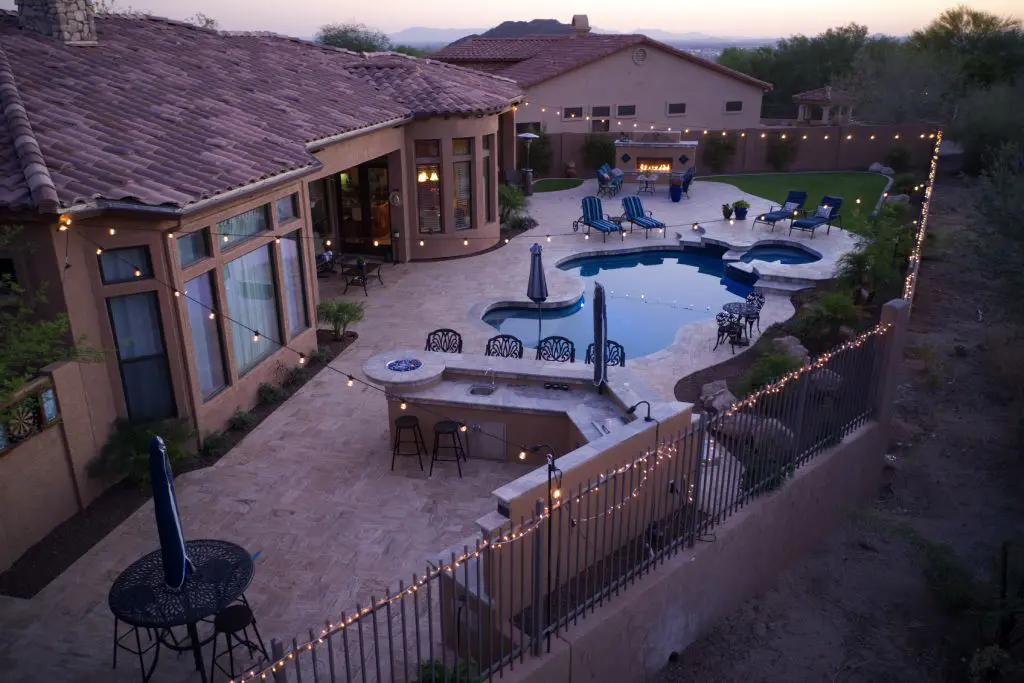 stunning, aerial view of a backyard example of a well-thought-out outdoor kitchen A stunning, aerial view of a backyard example of a well-thought-out outdoor kitchen cost plan and the results that you can achieve.