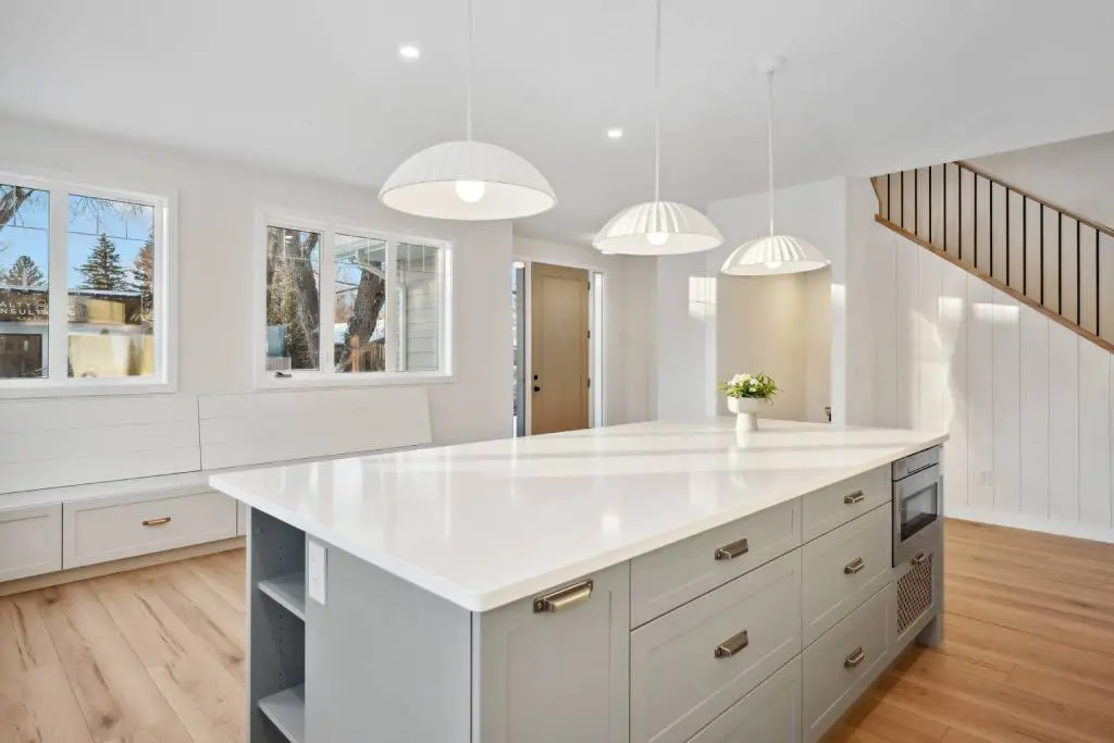 Bright modern kitchen with white island featuring built-in microwave drawer in island cabinetry Bright modern kitchen with white island featuring built-in microwave drawer in island cabinetry.